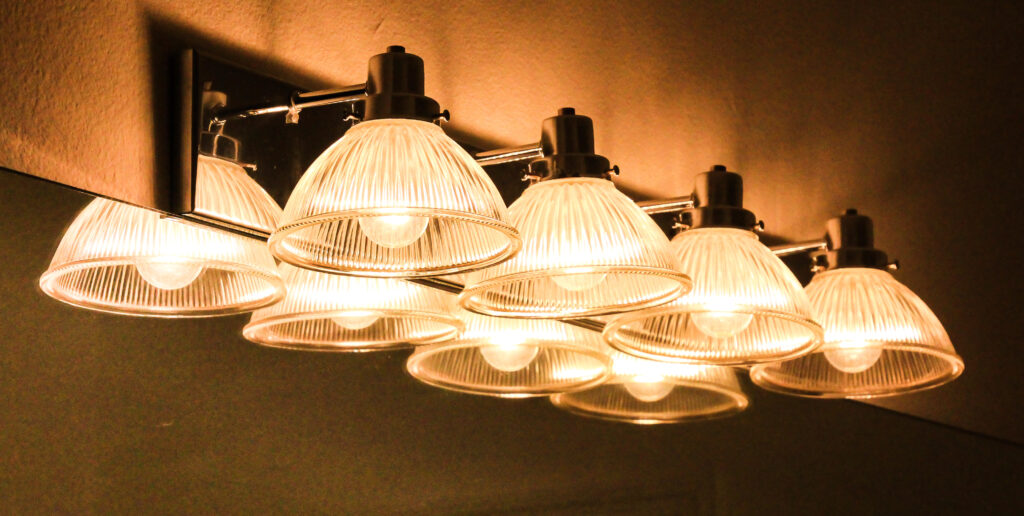 A golden toned light fixture in bathroom for the new year